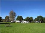 RVs camping on a vast, green expanse at CIRCLE CREEK RV RESORT - thumbnail