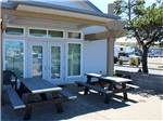 Picnic tables outside of a building - thumbnail