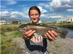 Girl holding a fish - thumbnail