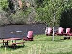 Picnic bench and chairs by the river at DOLORES RIVER RV RESORT BY RJOURNEY - thumbnail