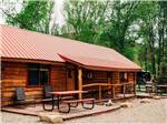 Cabin rental with deck and picnic bench at DOLORES RIVER RV RESORT BY RJOURNEY - thumbnail
