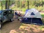 Jeep and tent in dirt site at DOLORES RIVER RV RESORT BY RJOURNEY - thumbnail
