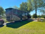 A Class A motorhome parked in a gravel site at TIFTON RV PARK I-75 (FORMERLY TIFTON KOA) - thumbnail
