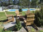 Chairs and fire pit next to the swimming pool at TIFTON RV PARK I-75 (FORMERLY TIFTON KOA) - thumbnail