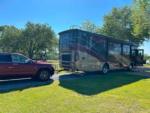 A motorhome and card parked in a RV site at TIFTON RV PARK I-75 (FORMERLY TIFTON KOA) - thumbnail