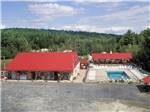 View larger image of An aerial view of the pool and main buildings at TWIN TAMARACK FAMILY CAMPING  RV RESORT image #11
