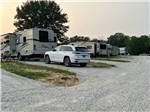 A row of motorhomes and trailers in gravel sites at HICKORY RIDGE CAMPGROUND - thumbnail