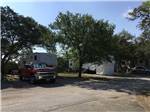 A truck and fifth wheel trailer in a RV site at TEXAS 281 RV PARK - thumbnail