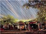 A long exposure shot of the campsites with stars over it at PALM CANYON HOTEL AND RV RESORT - thumbnail