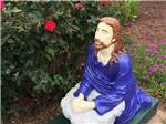 A statue of Jesus kneeling at LEISURE ACRES CAMPGROUND - thumbnail