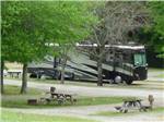 Wooden picnic benches at the RV sites at LEISURE ACRES CAMPGROUND - thumbnail