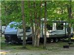 View larger image of A travel trailer under trees at INDIAN ROCK RV PARK image #4