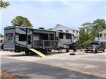 View larger image of A toy hauler parked in one of the RV sites at RIVERS END CAMPGROUND image #5