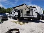 View larger image of A travel trailer parked in one of the sites at RIVERS END CAMPGROUND image #7