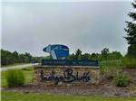 Welcome sign outside property at INDIGO BLUFFS RV PARK AND RESORT - thumbnail