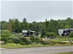 View from road of RVs parked at INDIGO BLUFFS RV PARK AND RESORT - thumbnail