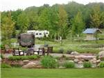 Outdoor seating with RVs in distance at INDIGO BLUFFS RV PARK AND RESORT - thumbnail