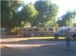 View larger image of Man walking toward campers gathered in front of RV at FALLON RV PARK image #7