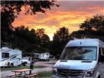 RVs on-site with beautiful sunset in distance at MEMPHIS GRACELAND RV PARK & CAMPGROUND - thumbnail