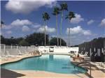 View larger image of A view of the pool with lounge chairs at TEXAS TRAILS RV RESORT image #1