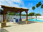 View larger image of A gazebo sitting next to the pool at TEXAS TRAILS RV RESORT image #7