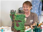 View larger image of A lady enjoying doing crafts at TEXAS TRAILS RV RESORT image #8
