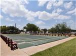 View larger image of A long row of shuffleboard courts at TEXAS TRAILS RV RESORT image #12