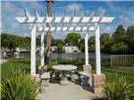 View larger image of A concrete table and benches under a pergola at JA-MAR NORTH RV RESORT image #11