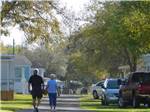 View larger image of A couple holding hands walking down the road at THE SPRINGS RV RESORT image #3