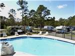The swimming pool with lounge chairs at LAKE AIRE RV PARK & CAMPGROUND - thumbnail