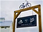 View larger image of Front entrance sign with a bicycle on top at OLD BARN RESORT image #2