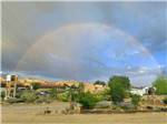 A rainbow forms in the sky at CANYONS OF ESCALANTE RV PARK - thumbnail