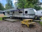 Parked trailer with patio area at Seven Mountains Campground & Cabins - thumbnail