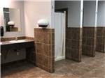 View larger image of The clean bathroom and shower stalls at COWBOY RV PARK image #5