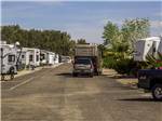 Class A Motorhome driving to camping spot at TWENTYNINE PALMS RESORT RV PARK AND COTTAGES - thumbnail