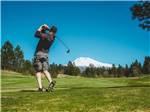 A man playing golf on a scenic golf course at TRAILER LANE CAMPGROUND - thumbnail