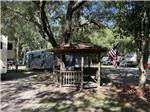 Gazebo with motorhomes in campsites at KELLY'S COUNTRYSIDE RV PARK - thumbnail