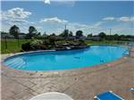 View larger image of Swimming pool with campers in background at OCEAN SURF RV PARK image #6