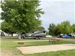 Class A motorhome parked in a gravel site at R & R Campground & RV Park - thumbnail