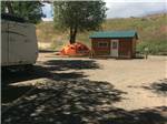 A tent pitched up next to a cabin at EAGLE RV PARK & CAMPGROUND - thumbnail