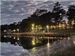 The fishing dock lit up at night at SUNSET KING LAKE RV RESORT - thumbnail
