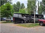 A motorhome in a gravel RV site at FOSSIL VALLEY RV PARK - thumbnail