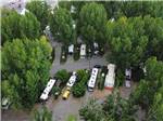 An aerial view of the pull thru RV sites with trees at FOSSIL VALLEY RV PARK - thumbnail