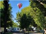 A hot air balloon over the campsites at FOSSIL VALLEY RV PARK - thumbnail