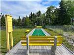 The shuffleboard court with yellow seats at HAROLD W. DUFFETT SHRINERS RV PARK - thumbnail