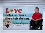  A banner of a child in a wheelchair at HAROLD W. DUFFETT SHRINERS RV PARK - thumbnail