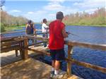 View larger image of Three people fishing from the dock at LAKE PAN RV VILLAGE image #5