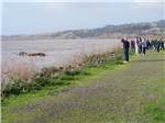 View larger image of A group of people looking at the river at RIVERWALK RV PARK  CAMPGROUND image #1