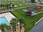 View larger image of A view of the swimming pool and play courts at OCALA SUN RV RESORT image #12