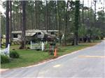 View larger image of Trailers camping among tall trees and white picket fences at SUGAR MILL RV PARK image #5